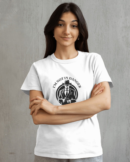 Woman wearing a white t-shirt with a graphic design and text against a gray background