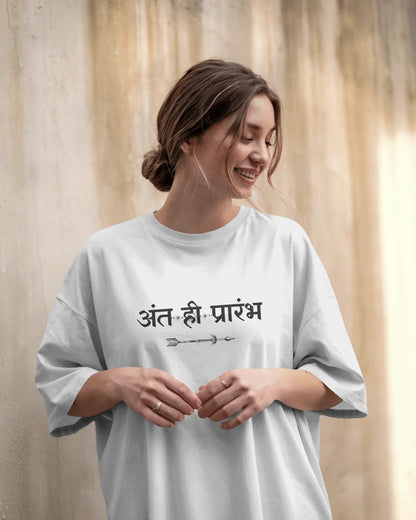 Woman wearing a white t-shirt with text against a beige curtain background