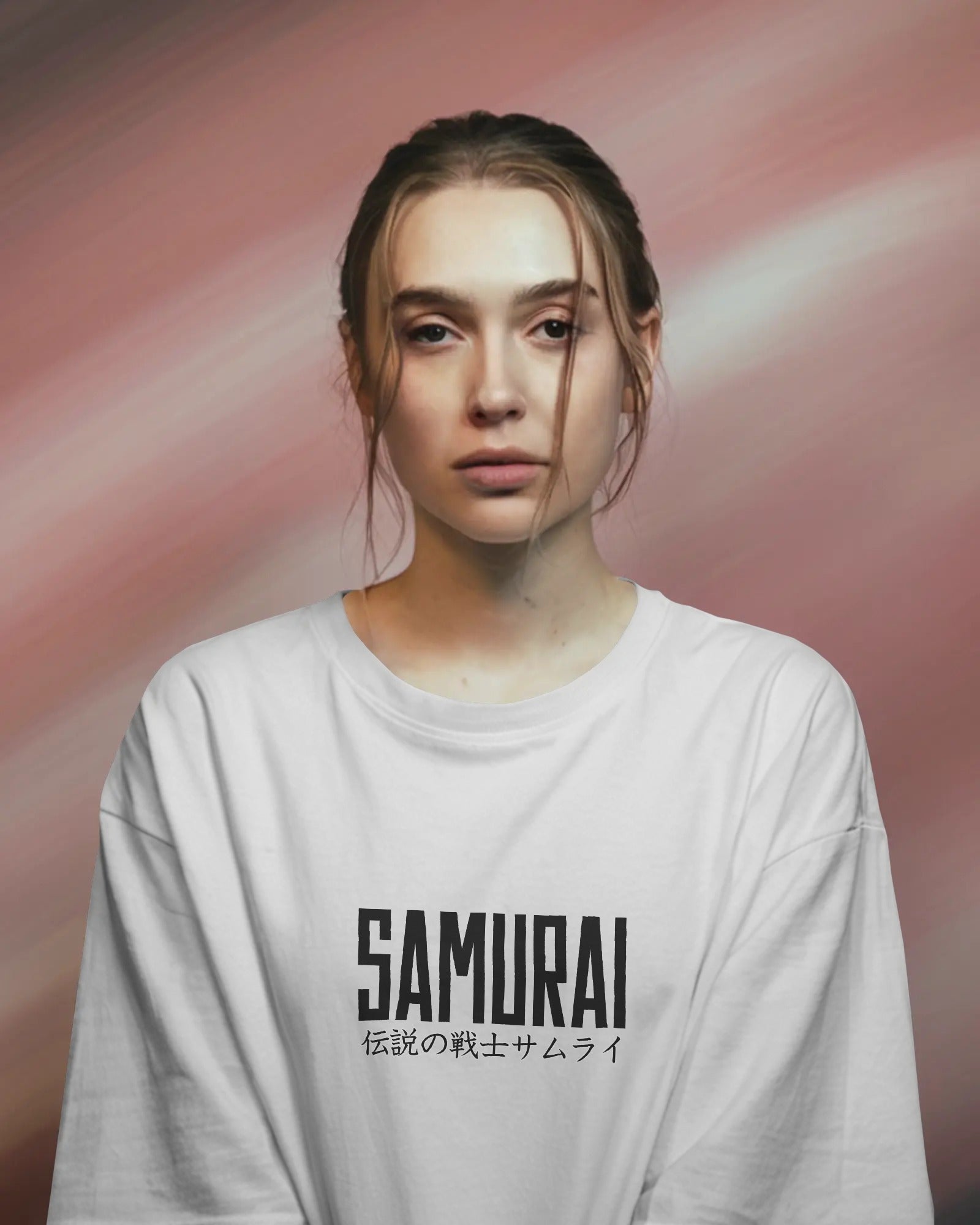Person wearing a white long-sleeve shirt with 'SAMURAI' text on a pink background