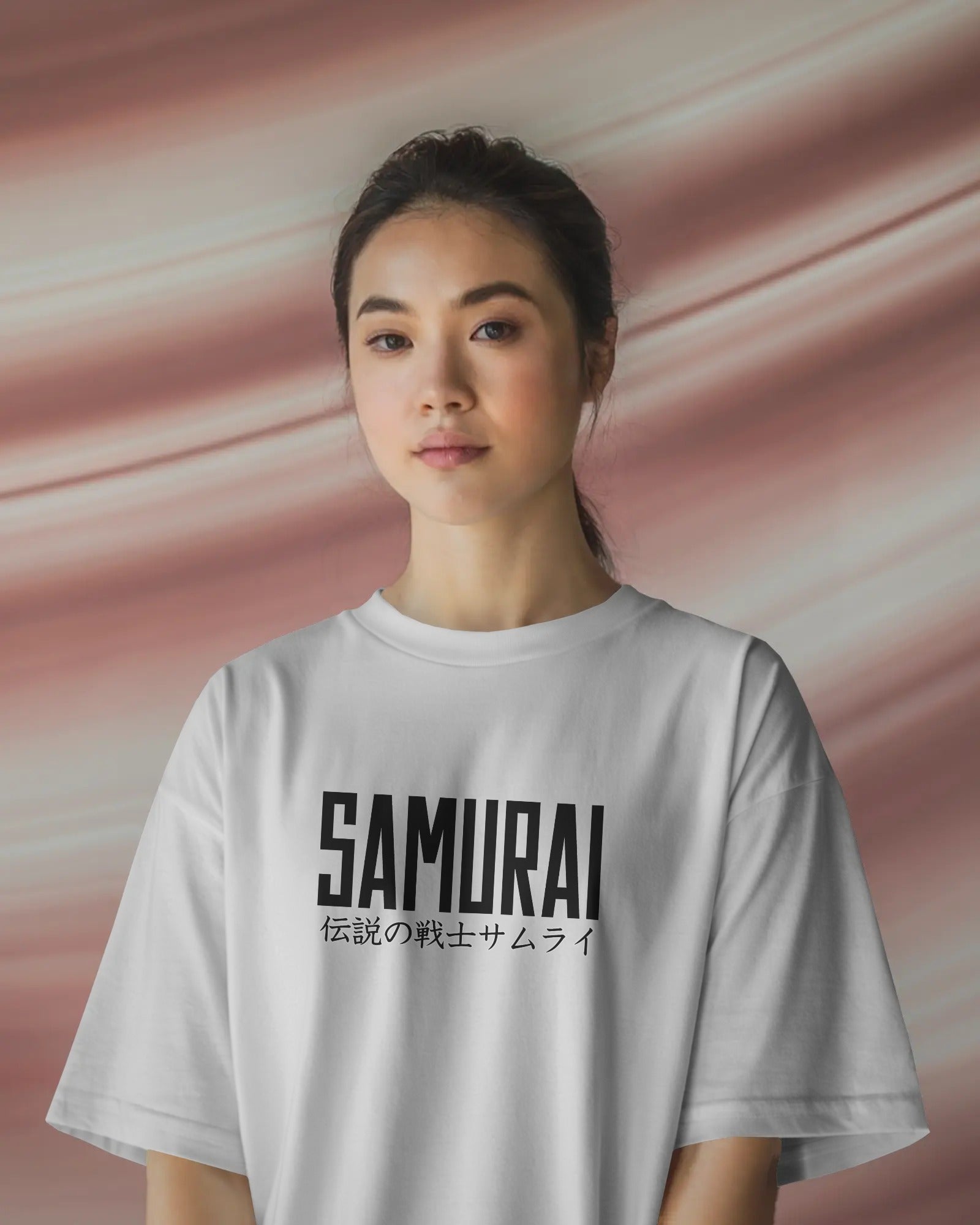 Person wearing a white t-shirt with 'SAMURAI' printed on it against a pink background