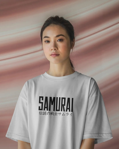 Person wearing a white t-shirt with 'SAMURAI' printed on it against a pink background